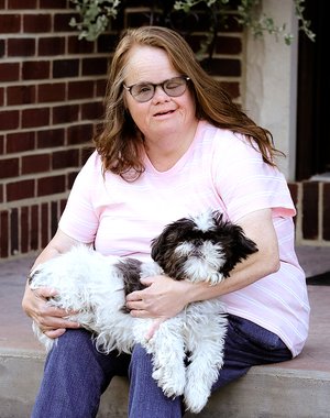 Denise Boozer standing on her porch.